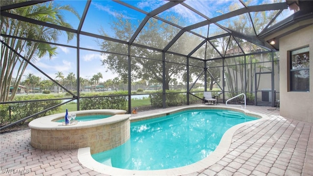 view of pool featuring glass enclosure, an in ground hot tub, and a patio