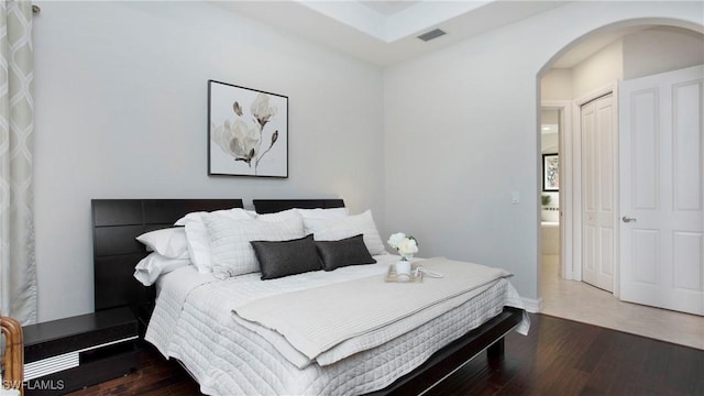 bedroom with hardwood / wood-style flooring and a closet