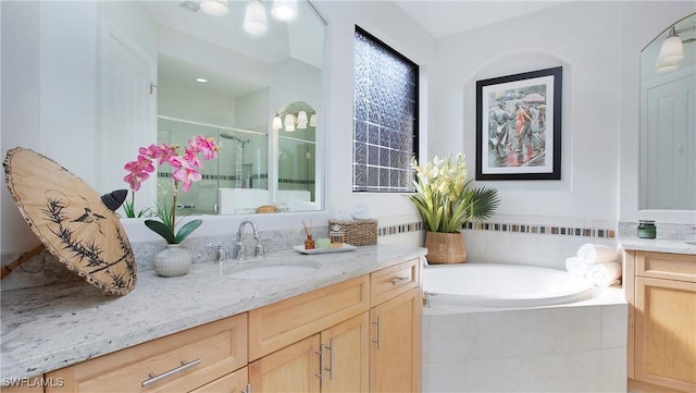 bathroom featuring vanity and separate shower and tub