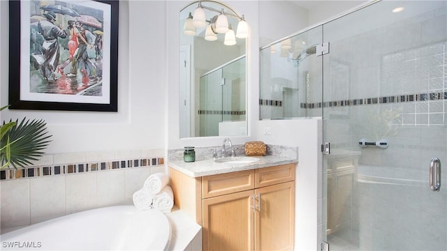 bathroom with vanity and separate shower and tub