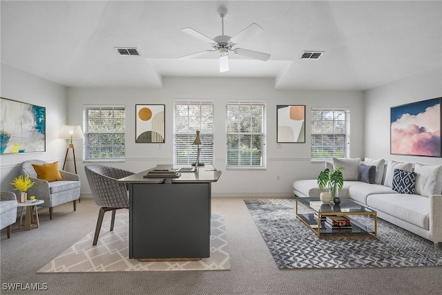 living room with ceiling fan, light carpet, and plenty of natural light