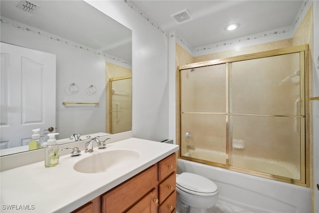 full bathroom featuring vanity, toilet, and combined bath / shower with glass door