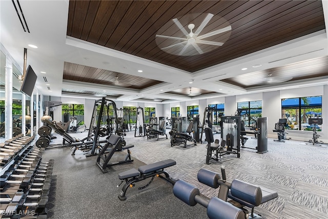 gym with ornamental molding, a raised ceiling, ceiling fan, and wooden ceiling