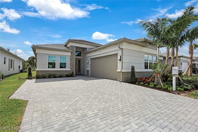 12216 Lotus Ave, Naples, FL 34120 - prairie-style home featuring a garage