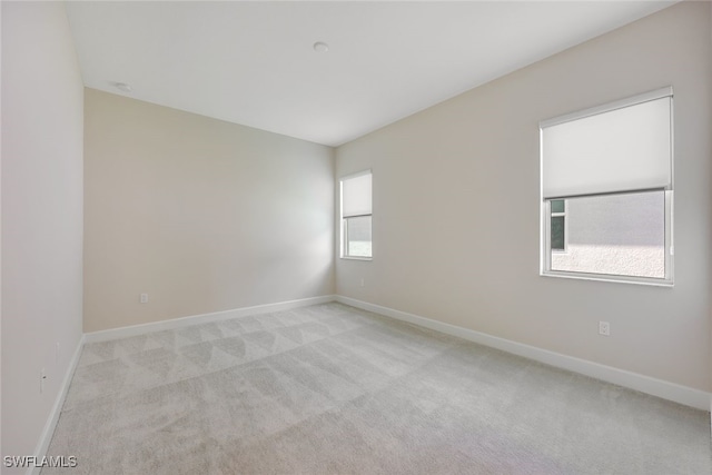 carpeted empty room with plenty of natural light