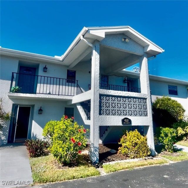 view of side of property with a balcony