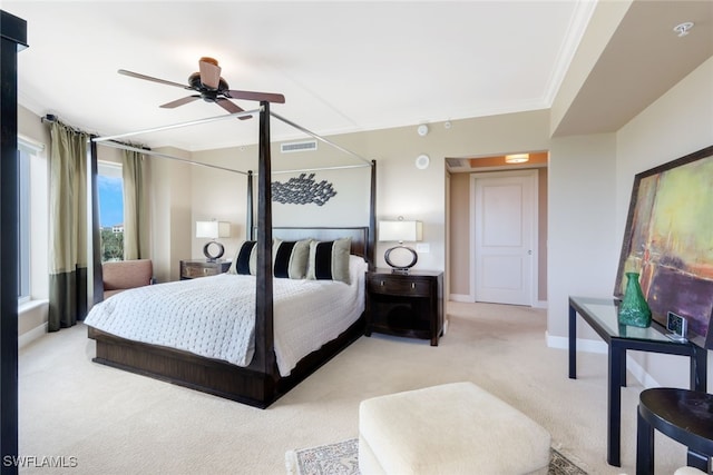 carpeted bedroom with ceiling fan and crown molding