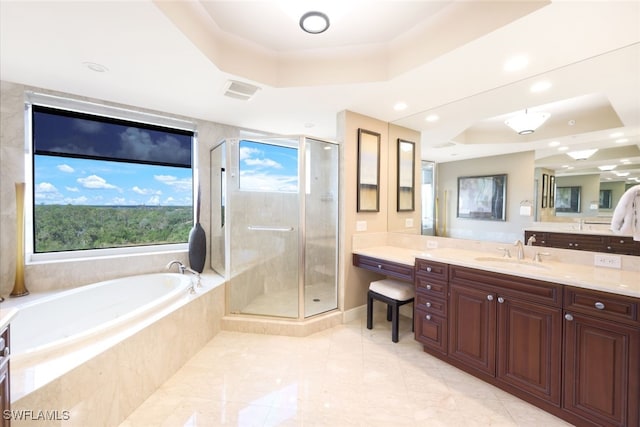 bathroom with vanity, separate shower and tub, and a raised ceiling