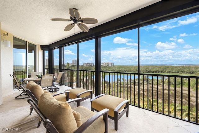 sunroom featuring ceiling fan