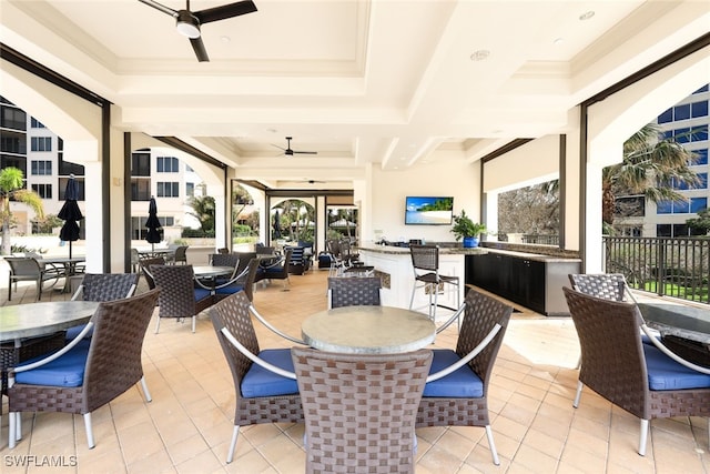 tiled dining room with a wealth of natural light, crown molding, and ceiling fan