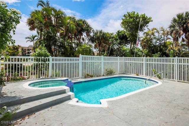 view of swimming pool with an in ground hot tub and a patio area