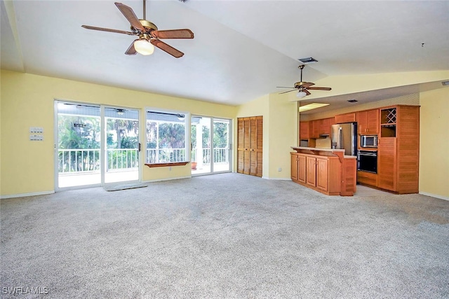 unfurnished living room featuring lofted ceiling, light colored carpet, and ceiling fan