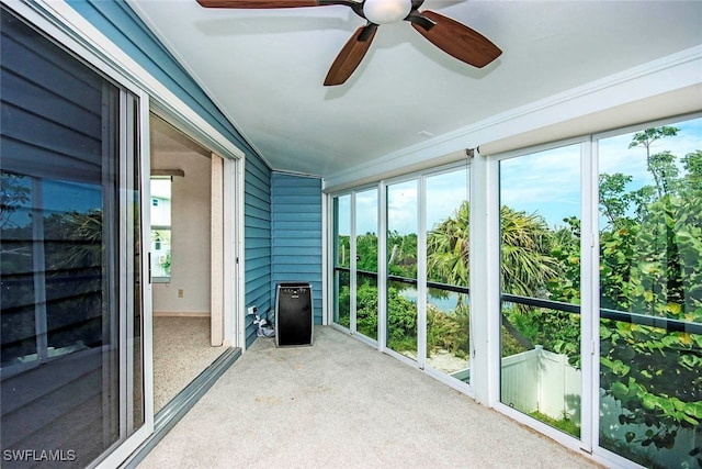 unfurnished sunroom featuring ceiling fan