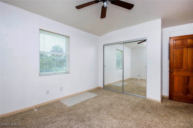 unfurnished bedroom with a closet, carpet flooring, and ceiling fan