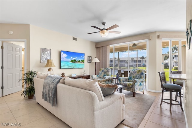 tiled living room featuring ceiling fan