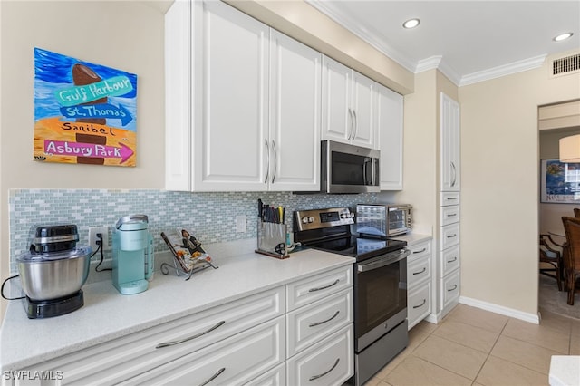 kitchen featuring decorative backsplash, light tile patterned floors, ornamental molding, white cabinetry, and stainless steel appliances