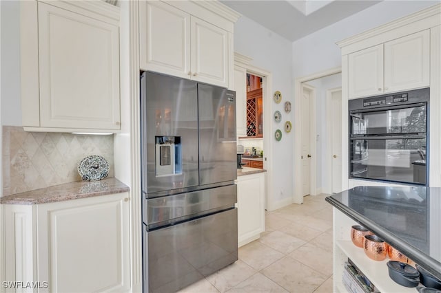 kitchen with white cabinetry, decorative backsplash, light tile patterned floors, black double oven, and stainless steel refrigerator with ice dispenser