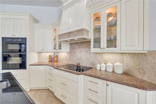 kitchen featuring white cabinetry, black appliances, and decorative backsplash