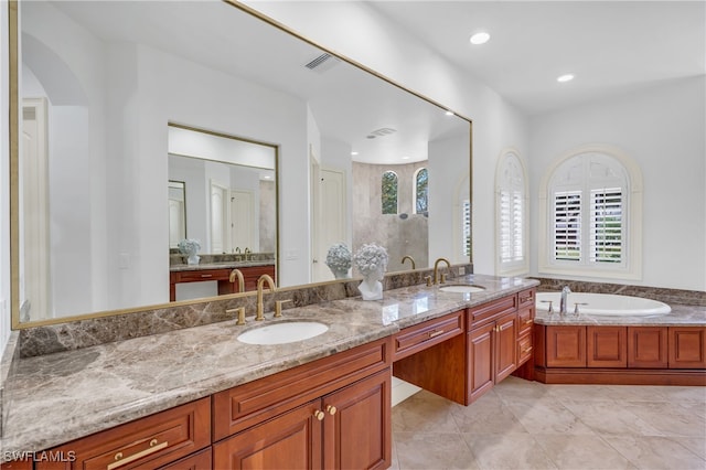 bathroom featuring vanity, a wealth of natural light, a bath, and tile patterned flooring