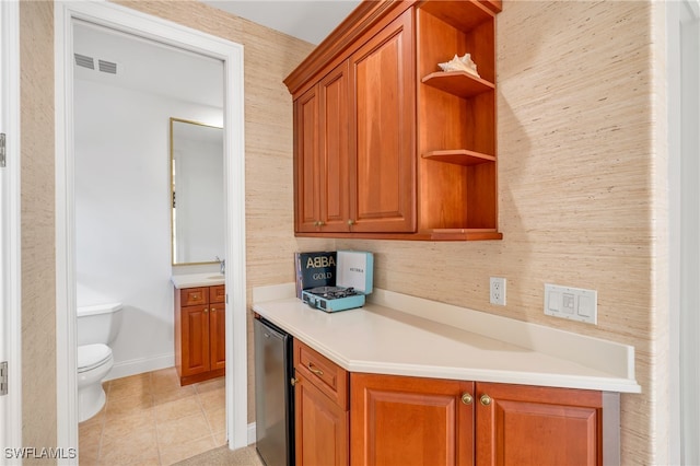 kitchen with stainless steel refrigerator and light tile patterned flooring