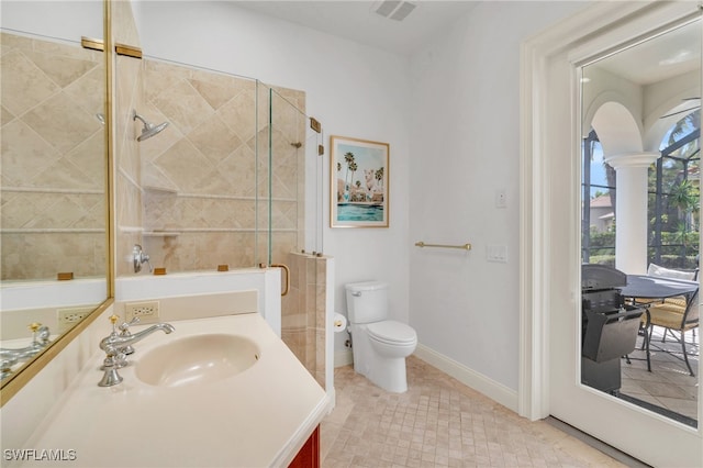 bathroom featuring decorative columns, toilet, vanity, an enclosed shower, and tile patterned floors