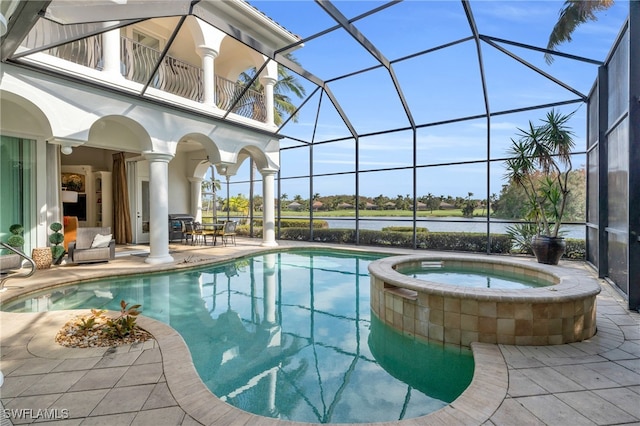 view of swimming pool with an in ground hot tub, a patio area, glass enclosure, and a water view