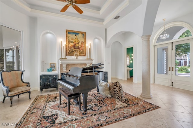 miscellaneous room with french doors, a tray ceiling, ornate columns, ceiling fan, and crown molding