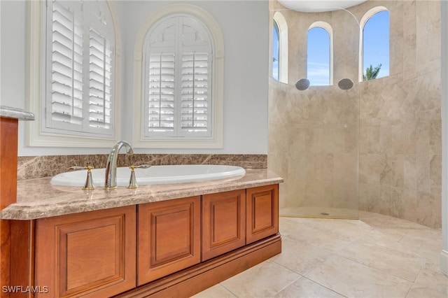 bathroom featuring tile patterned flooring, sink, and shower with separate bathtub