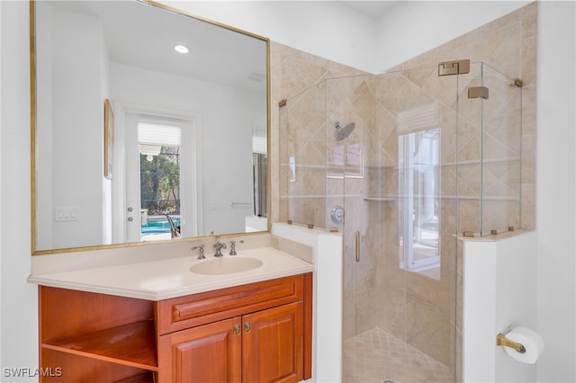 bathroom featuring vanity and an enclosed shower