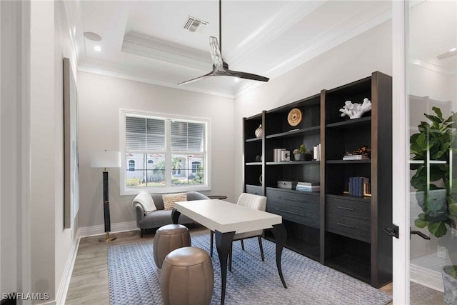 office space with ceiling fan, ornamental molding, and light hardwood / wood-style flooring