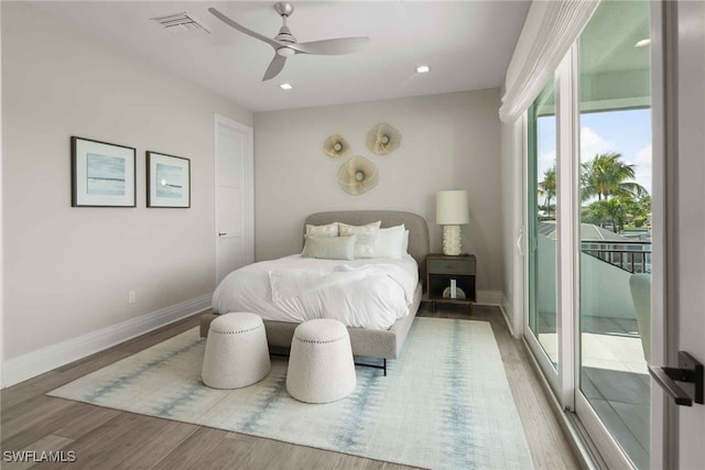 bedroom featuring hardwood / wood-style flooring, access to outside, and ceiling fan