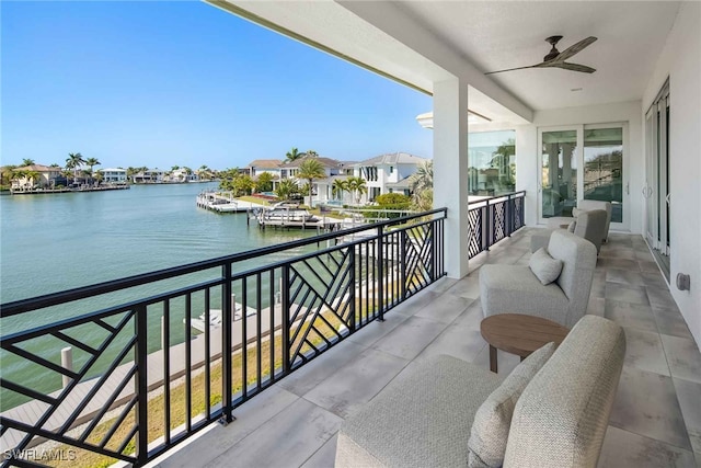 balcony with a water view and ceiling fan