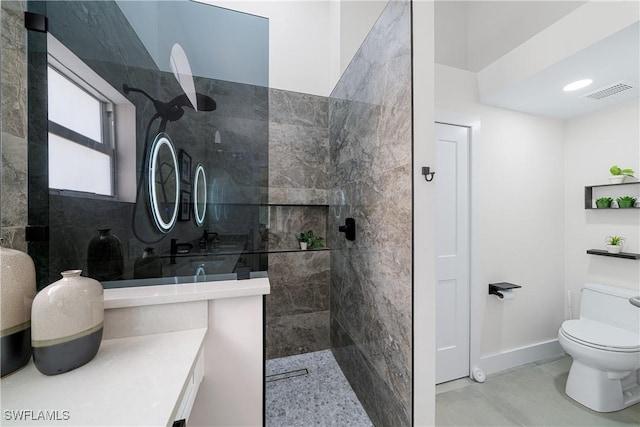 bathroom with toilet and a tile shower