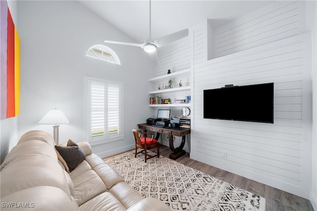 living room with light wood-type flooring, high vaulted ceiling, and ceiling fan