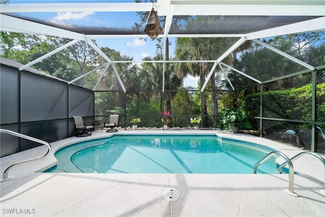 view of pool with a patio and glass enclosure