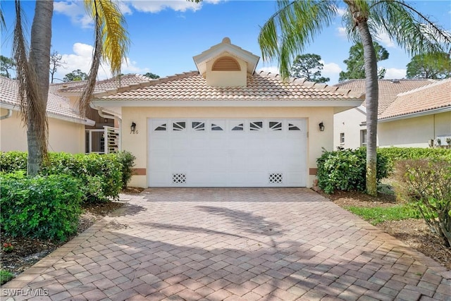 mediterranean / spanish-style house with a garage