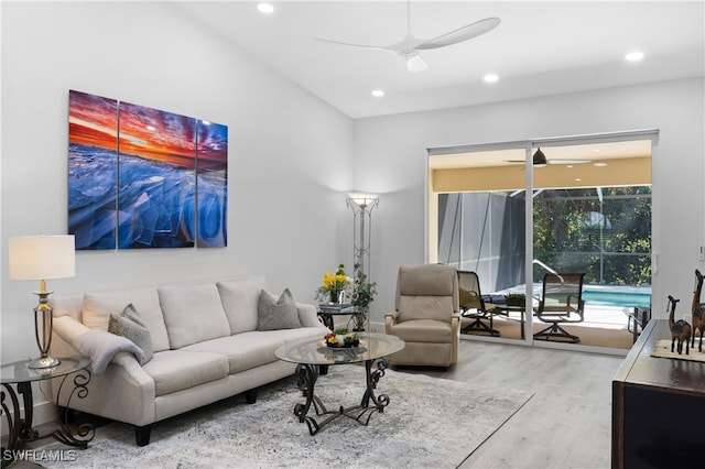 living room with light hardwood / wood-style floors and ceiling fan