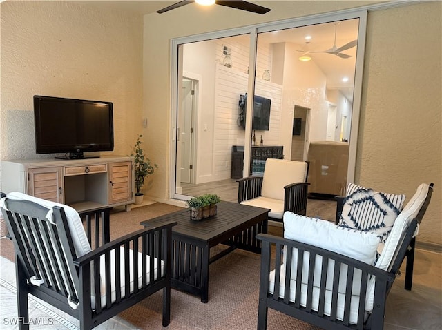 interior space with outdoor lounge area and ceiling fan