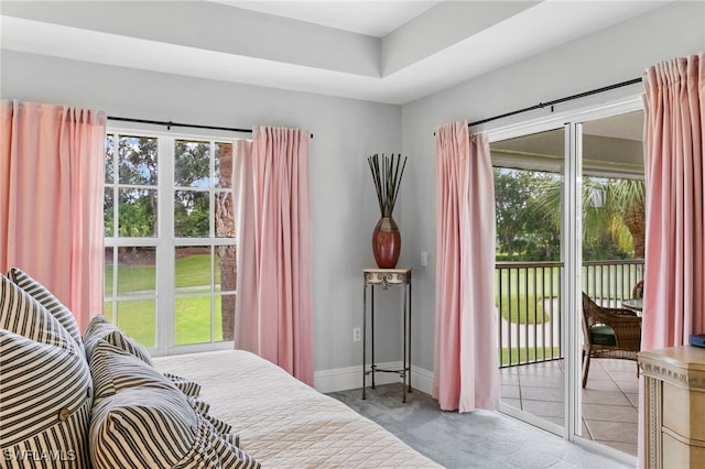 carpeted bedroom featuring multiple windows and access to exterior