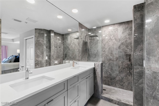 bathroom featuring vanity and tiled shower