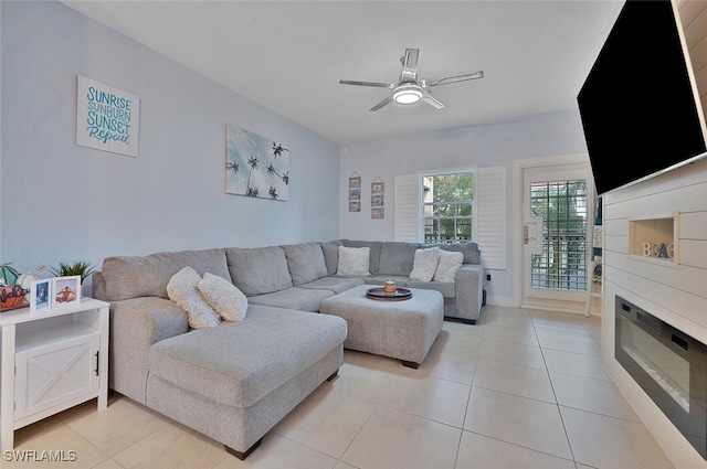 living room featuring ceiling fan and light tile patterned floors