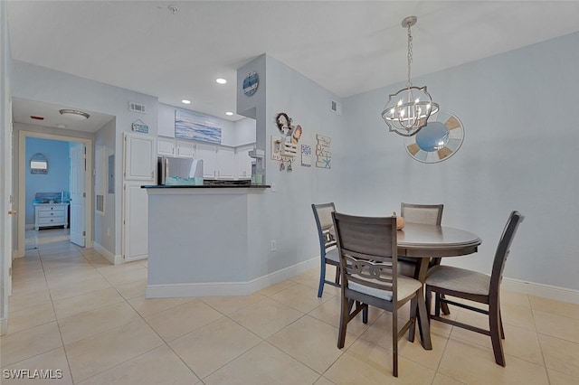 dining area featuring an inviting chandelier and light tile patterned floors