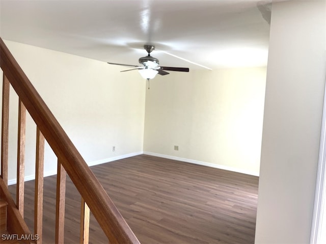 spare room with dark hardwood / wood-style floors and ceiling fan