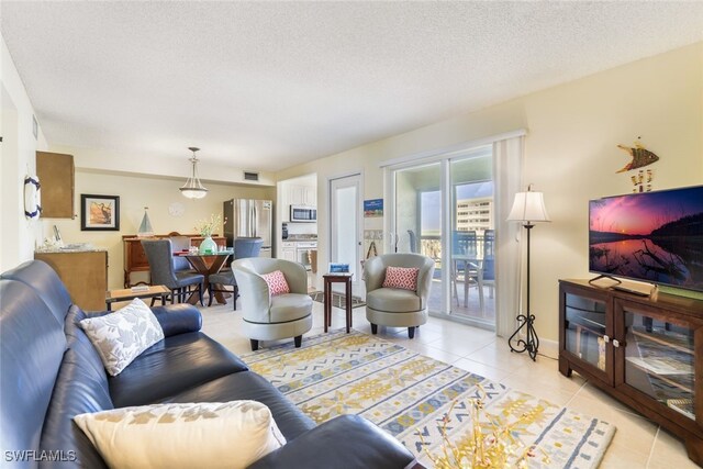 living room with light tile patterned flooring and a textured ceiling