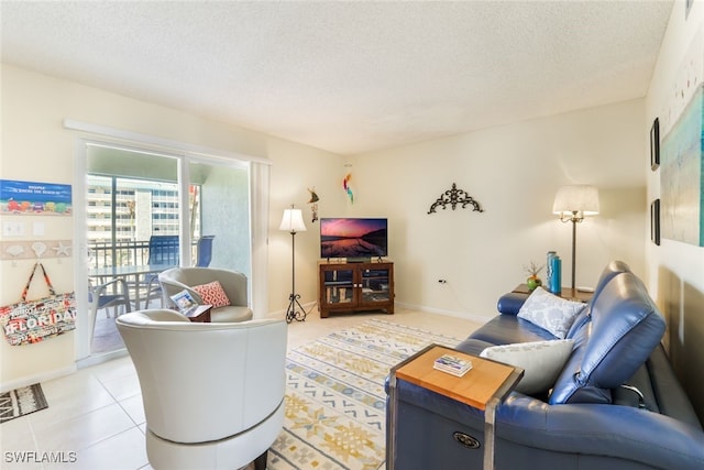 living room featuring light tile patterned floors, baseboards, and a textured ceiling