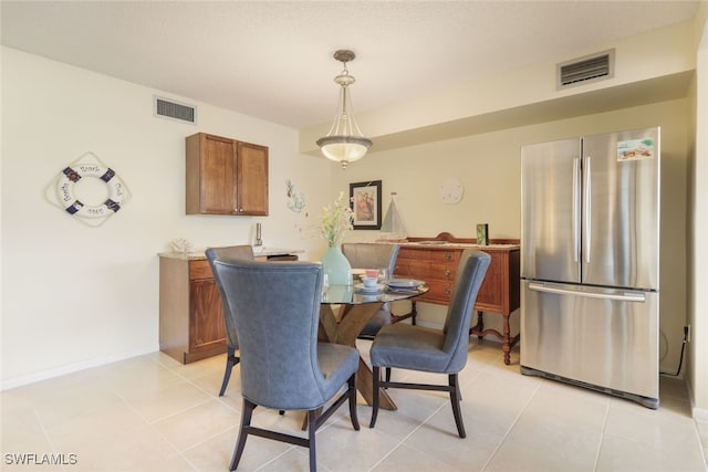 dining space featuring light tile patterned floors