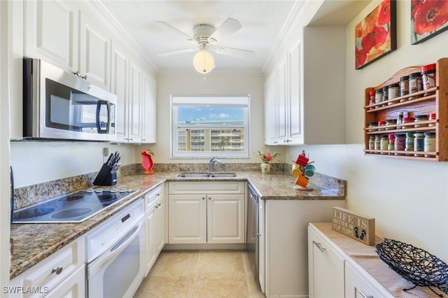 kitchen with stone countertops, sink, white cabinets, ornamental molding, and white appliances