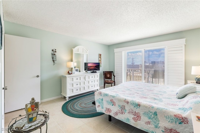 tiled bedroom with access to exterior and a textured ceiling