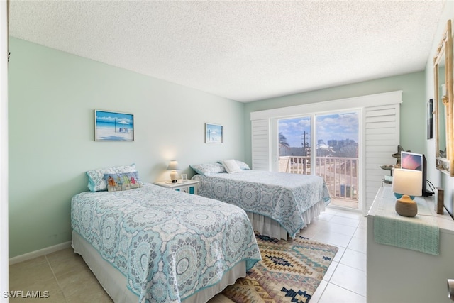 tiled bedroom featuring a textured ceiling and access to outside