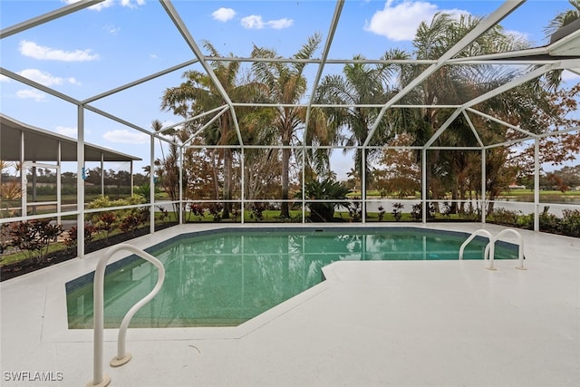 view of swimming pool with a patio area and a lanai